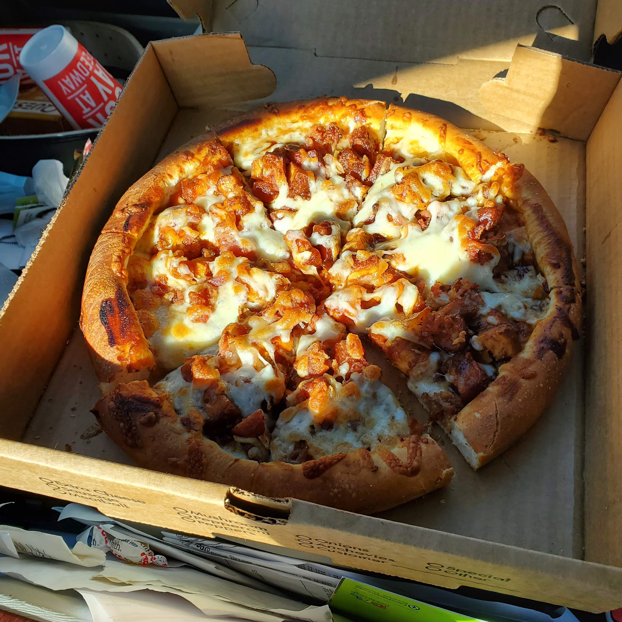 Golden pizza in its takeout box from Epsom House of Pizza